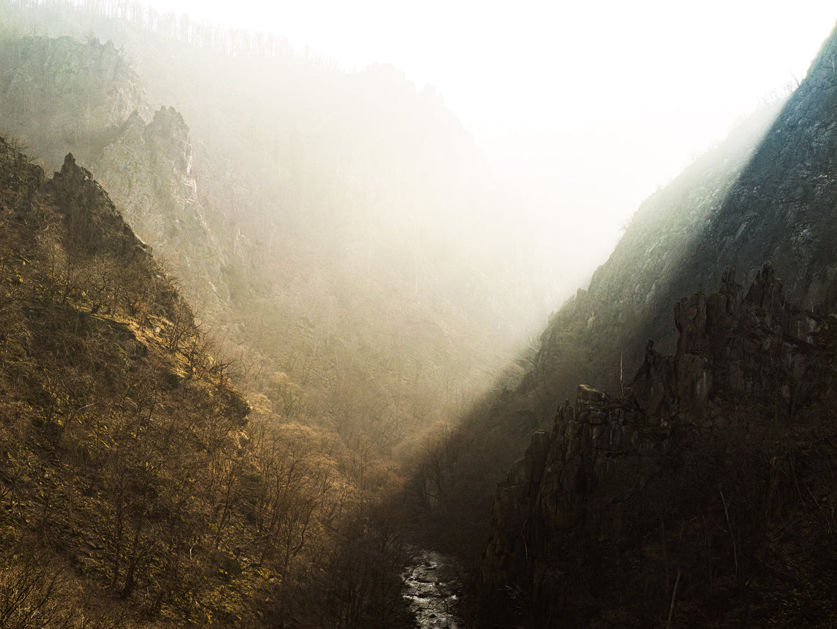 Mattes Poster Bodetal von Bachblatt – Motivansicht des nebligen Tals mit Sonnenstrahlen und Felsen.